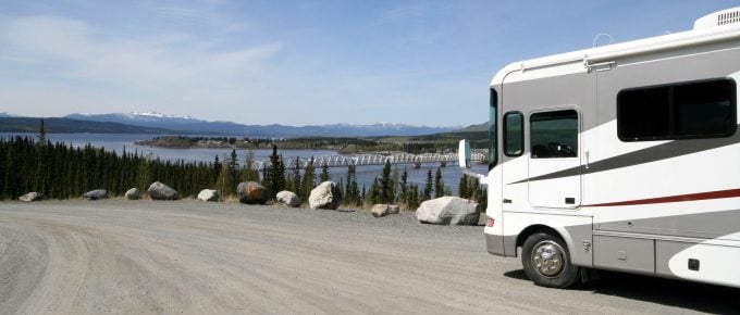 RV boondocking in a dirt lot with water view
