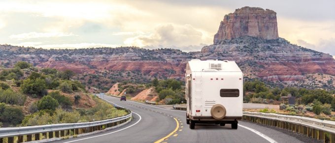 White Color fifth wheel Goes On Road On Background Of Mountains