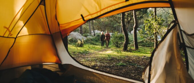 a couple walking away from their tent