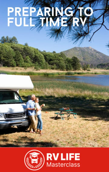 older couple by lake with class C motorhome