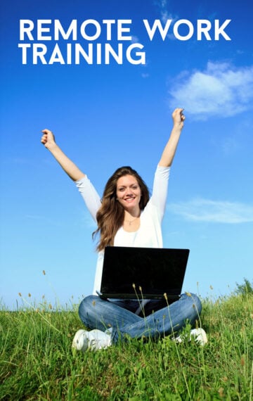 woman sitting outside with arms stretched above and laptop